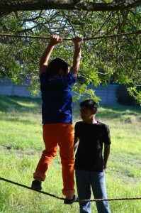 Cubs doing the obstacle course with the scouts close by to assist